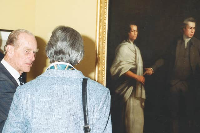 Prince Philip looks at the Mai painting at Captain Cook Museum.