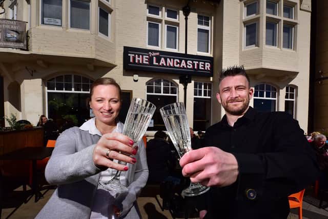 Managers Lelde Caune and Ray Clarkson make a toast to the big opening day.