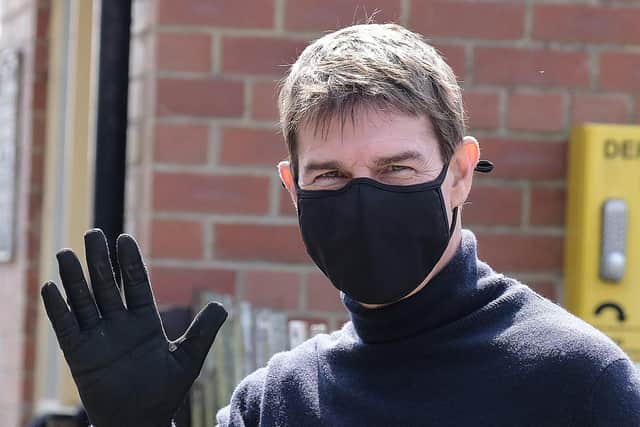 Tom Cruise waves to onlookers in Levisham.