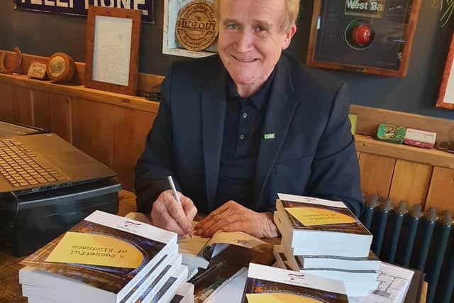 Saint Cecilia’s Care Group MD, Mike Padgham, signing books for his staff.