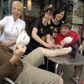 Getting their legs waxed for charity are Costa baristas Richard Halawin, left, and Thomas Davis.
