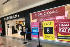 Poster in window displays countdown to Debenhams store closure.