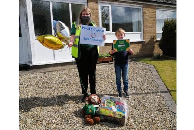 Community Champion for the Scarborough branch of the supermarket, Ellie Waite, presents Walter McNeill with his Little Sunshine award.