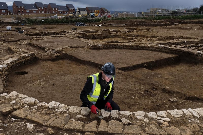 Trainee Field Archaeologist Corey Greening works on the site.