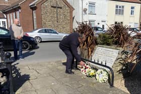 Flamborough Fishermen’s Memorial Group’s Robin Sunley lays a wreath. Photo Mark Smales.