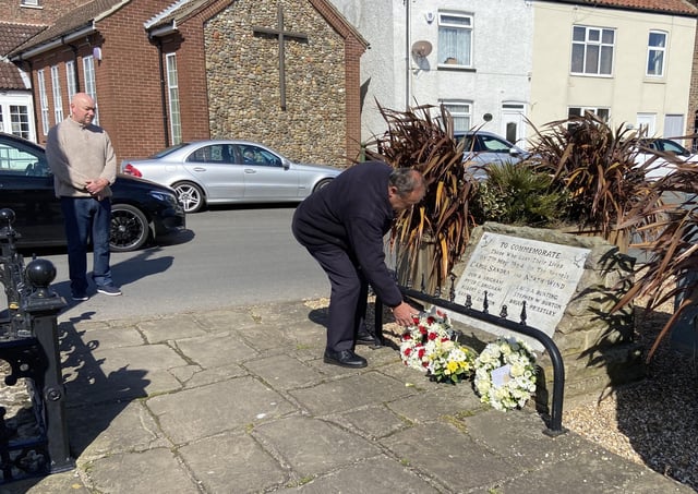 Flamborough Fishermen’s Memorial Group’s Robin Sunley lays a wreath. Photo Mark Smales.
