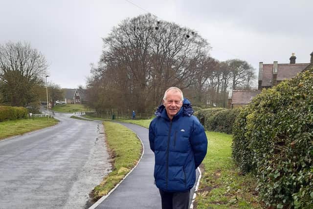Cllr Derek Bastiman standing on the new path.