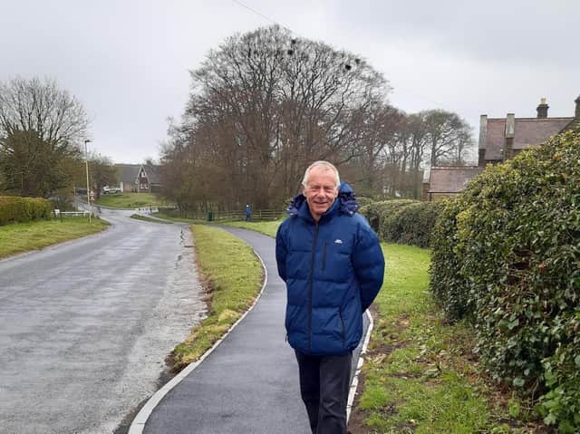 Cllr Derek Bastiman standing on the new path.