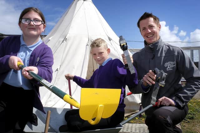 Pupils Krystal and Kyran work on the new eco garden, with staff member James Armstrong.