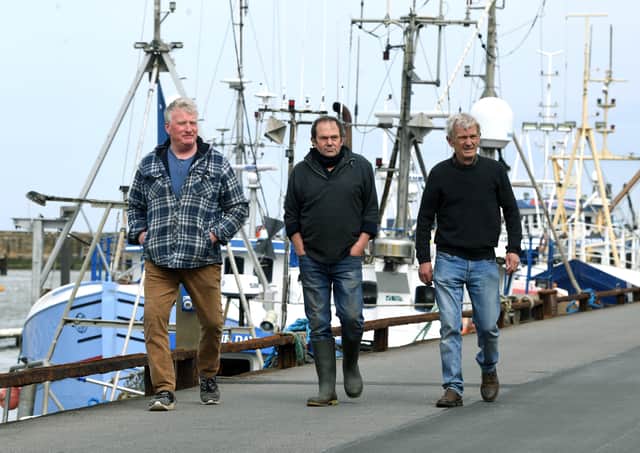 Fishermen, from left, Andrew Sanderson, Frank Powell and Shaun Wingham, are pictured at Bridlington harbour.
