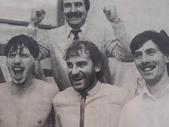 Whitby Town boss Tony Lee celebrates the cup final victory with, from left, Phil Linacre, Derek Hampton and Ronnie Sills