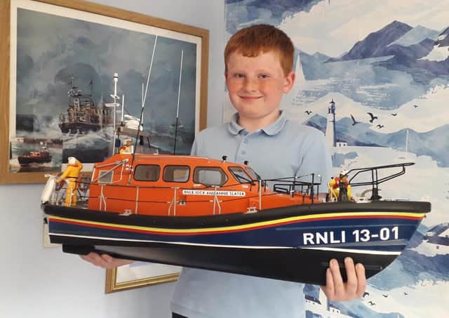 Bridlington Model Boat Society member Rowan Fothergill is pictured with the 1/16th Shannon Lifeboat.