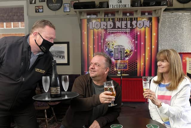 Lord Nelson landlord Peter Day serves Mark and Elaine Haston.