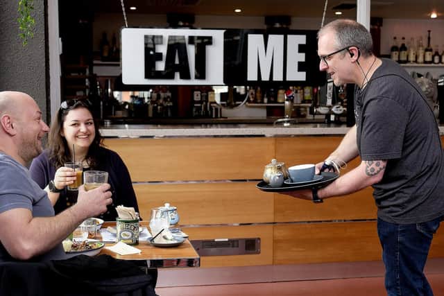 Guests Shaun Harrison and Katerina Christou are served by Stephen Dinardo at Eat Me.
