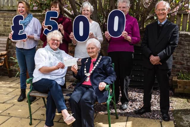 The Rainbow Centre's Trish Kinsella (front, left) receives a cheque for £500 from The Vale of York Oddfellows
