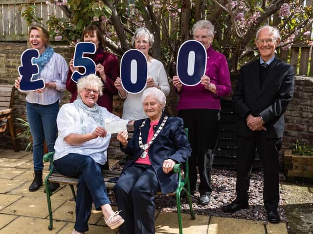 The Rainbow Centre's Trish Kinsella (front, left) receives a cheque for £500 from The Vale of York Oddfellows