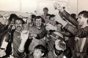 Scarborough FC legend Mitch Cook, pictured centre, celebrating Boro's promotion to the Football League.
