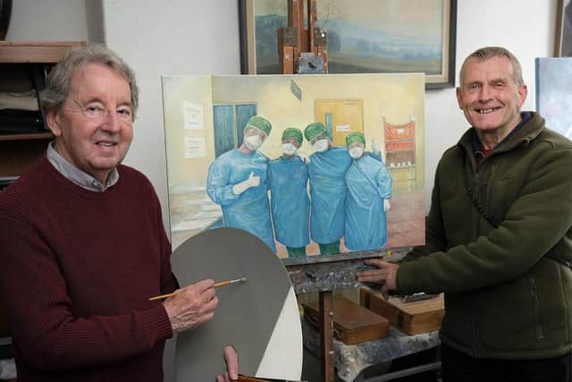 Mr Stuttle and Mr Grice with the original painting of the three nurses.