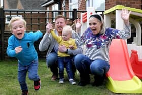 Archie Cook completes his fundraising garden laps with dad Nick, sister Izzy and mum Claire cheering him on.