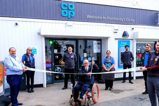 Local resident and customer Andy Hunter performs the ribbon cutting at Hunmanby Co-op. With staff, from left, Mark Ross, Kirstie Brignall,Nicholas Moorwood, Shelley Ross, Alex Groom, Connor Brignall, Steven Padley.