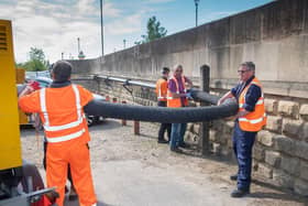 A crew sets up one of two new quiet pumps bought as part of the scheme.