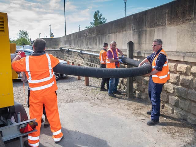 A crew sets up one of two new quiet pumps bought as part of the scheme.
