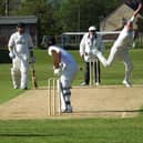 Tom Bumby, above in bowling action, hit 27 in Heslerton's win