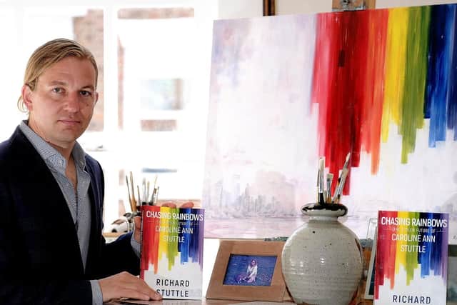 Richard Stuttle with a copy of his book and his original painting which is the front cover for the book.