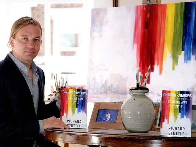 Richard Stuttle with a copy of his book and his original painting which is the front cover for the book.