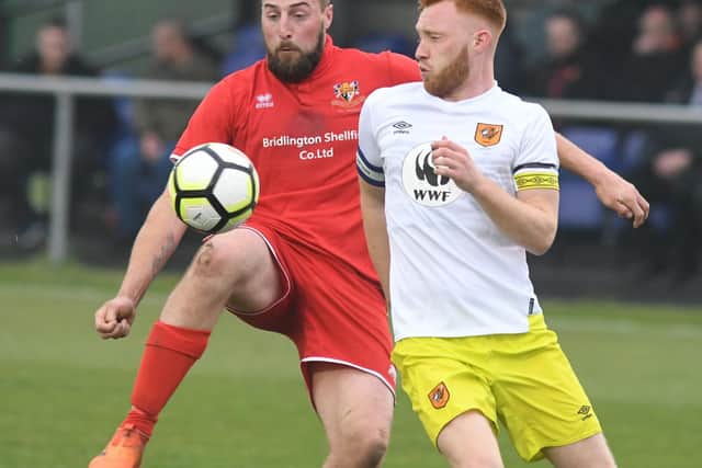 Jake Day in action for Brid Town against Hull City U23s' Lewis Ritson in the 2018-19 ER Senior Cup final