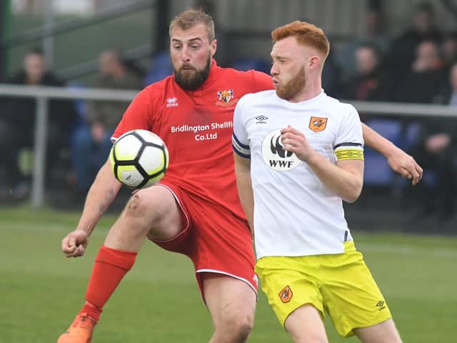 Jake Day in action for Brid Town against Hull City U23s' Lewis Ritson in the 2018-19 ER Senior Cup final