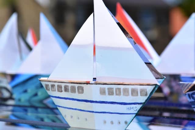 Origami ships head for the Yorkshire coast.
