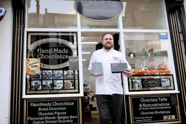 Alex Grant outside the shop in Newborough