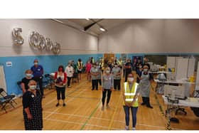 Staff and volunteers at the Rugby Club vaccination centre celebrate 50,000 vaccines.