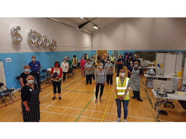 Staff and volunteers at the Rugby Club vaccination centre celebrate 50,000 vaccines.