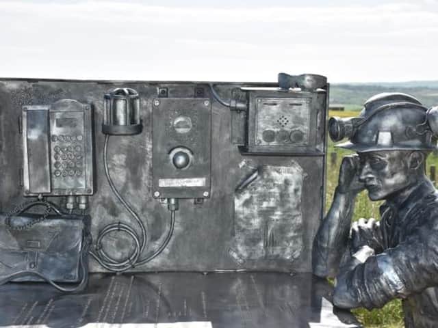 The miners statue sits at the bait table with representations of the type of equipment used in the early days of mining at Boulby.