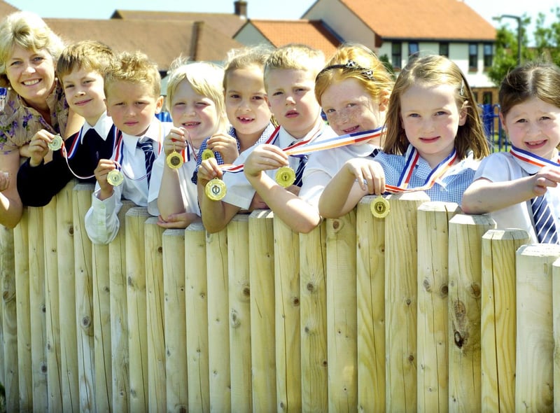 St Martin’s School winning athletics team with their trophy and medals.
