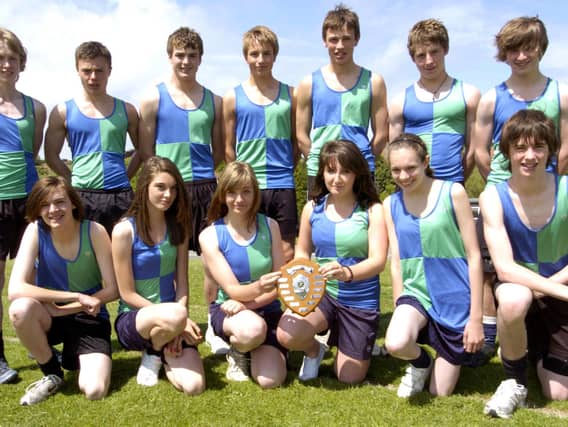 Whitby Community College athletics team with their trophy.