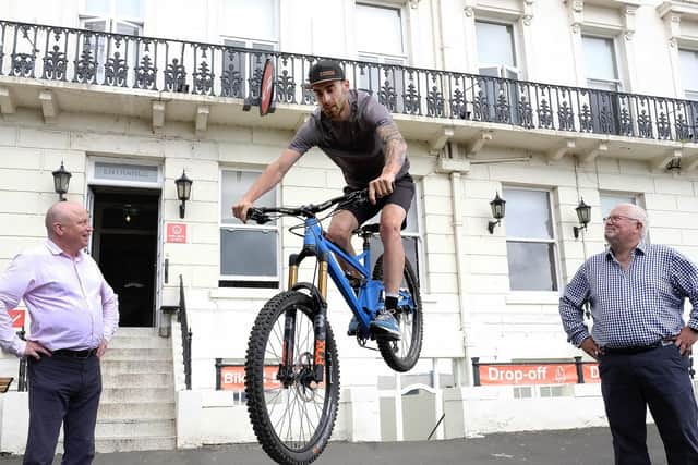 World champion Jack Carthy pictured with owners Simon Rhatigan, left and Simon Kershaw, right. Picture: JPI Media/ Richard Ponter