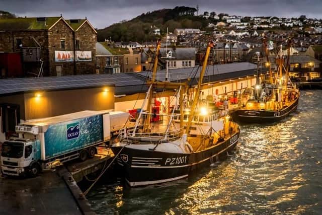 Last year's winning image by Laurence Hartwell entitled 'Beam trawlers landing to the fish market at night'.