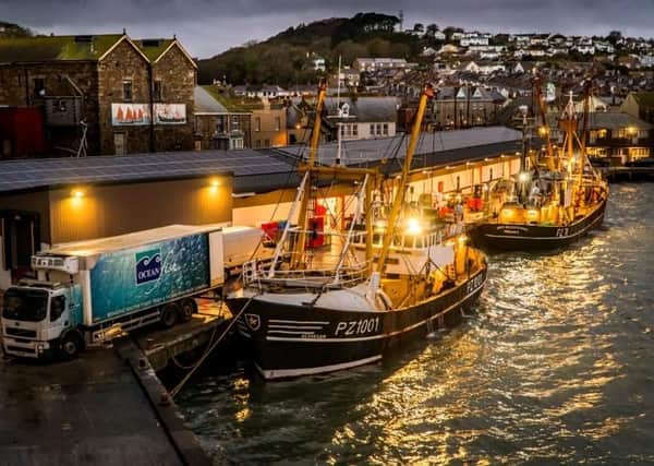 Last year's winning image by Laurence Hartwell entitled 'Beam trawlers landing to the fish market at night'.
