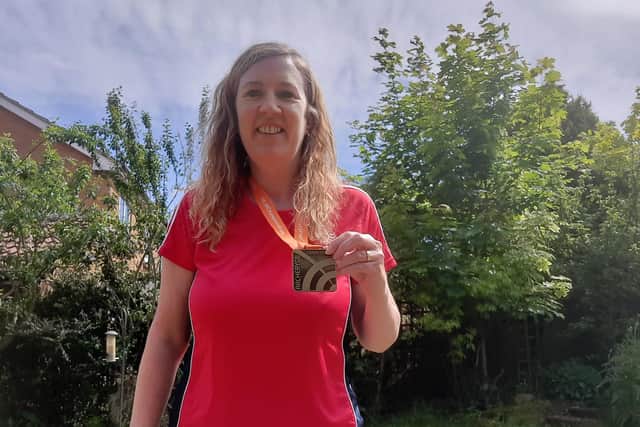 Sarah Monteith shows off her gold medal.