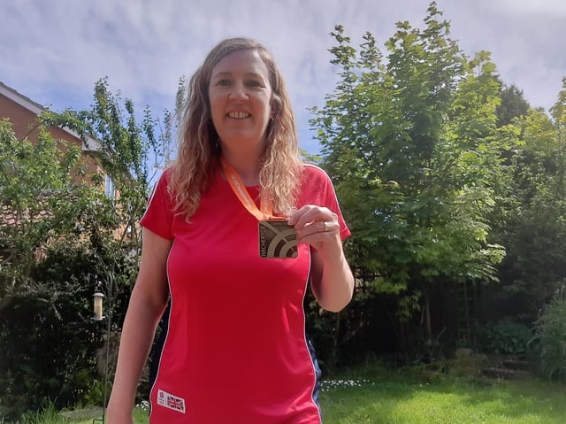 Sarah Monteith shows off her gold medal.