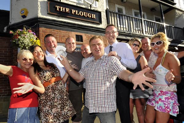 Clive Welburn, centre, Scalby’s Got Talent winner presents £200 to St Catherine’s Hospice director of  fundraising David Marshall, centre right, watched by his friends and fans at The Plough.
