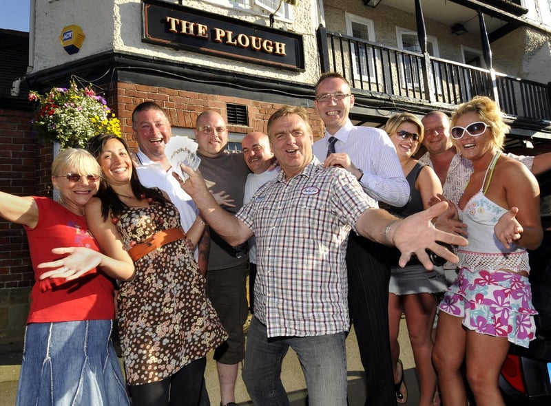 Clive Welburn, centre, Scalby’s Got Talent winner presents £200 to St Catherine’s Hospice director of fundraising David Marshall, centre right, watched by his friends and fans at The Plough.