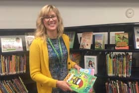 Laura Hellfeld of Kokopie Families wearing one of the lanyards in a county library