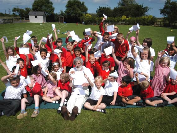 John Barber, head teacher of Hawsker Primary School, celebrates the school’s good Ofsted report with his pupils.