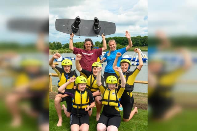 Rocco Burbidge with Scarborough College students and a member of the waterpark staff