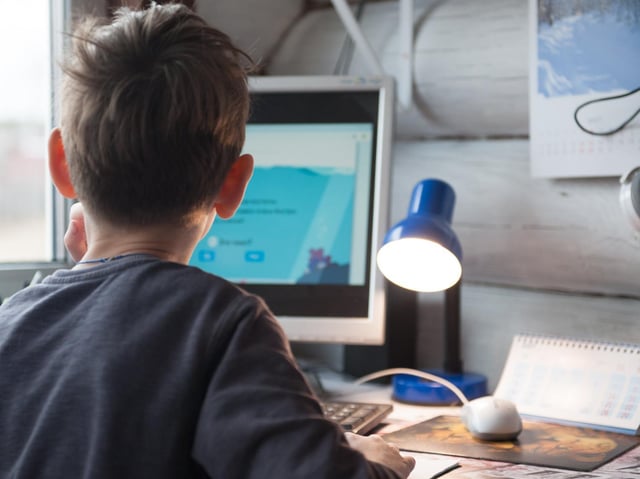 Stock image, child remote learning at home.