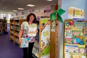 Outreach Librarian Adele Duffield at Whitby Library, with the Summer Reading Challenge certificates.